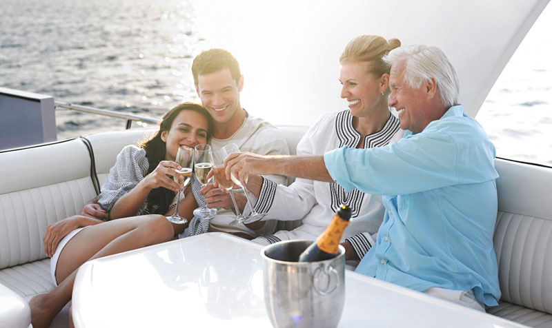 family drinking champagne on a yacht